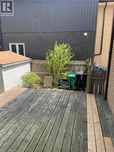 Wood deck with partial new boards, fenced perimeter, and a detached storage shed - 124 Avalon Place, Kitchener, ON 