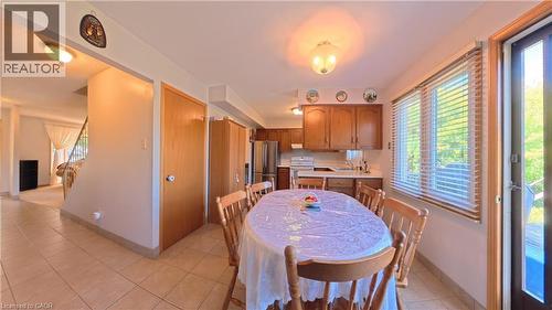 Kitchen with wood cabinetry, stainless steel appliances, and tile flooring - 56 Scenic Wood Crescent, Kitchener, ON 