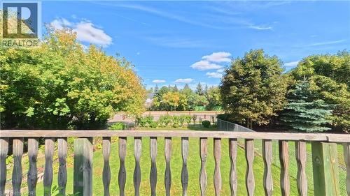 Manicured lawn with mature trees and a chain-link fence - 56 Scenic Wood Crescent, Kitchener, ON 