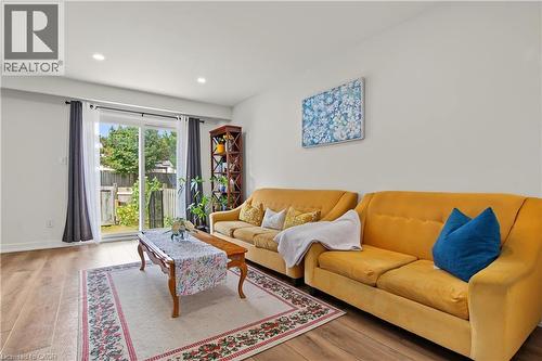 Wood-finish flooring, recessed lighting, white walls, and a sliding glass door to the backyard - 1444 Upper Ottawa Street Unit# 32, Hamilton, ON 