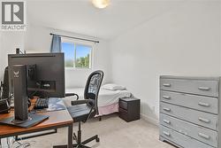Recessed window with exterior views, light-toned carpeting, and a ceiling-mounted light fixture - 