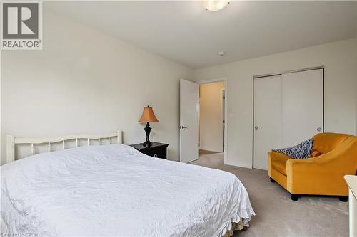 Carpeted flooring, white walls, white interior door, and built-in sliding closet doors - 1444 Upper Ottawa Street Unit# 32, Hamilton, ON 
