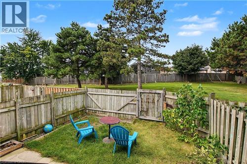 Fenced yard with a grass lawn and mature trees - 1444 Upper Ottawa Street Unit# 32, Hamilton, ON 