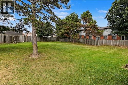 Expansive grassy yard featuring mature trees and a full privacy fence - 1444 Upper Ottawa Street Unit# 32, Hamilton, ON 