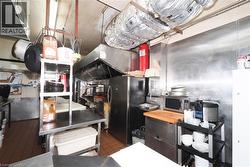 Stainless steel wall paneling, tile flooring, and integrated stainless steel countertops - 