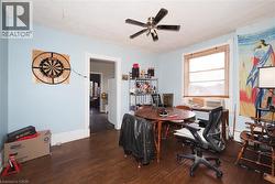 Wood-finish flooring with light blue walls and white trim - 
