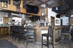 Expansive bar area featuring a wood-finish bar top, integrated tap system, and decorative ceiling panels - 