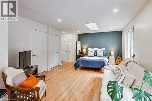 Wood-finish flooring, recessed lighting, skylight, multiple paneled doors, and a large window - 35 Shirlea Boulevard, Keswick, ON 