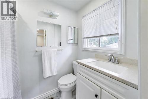White single vanity with integrated sink, chrome faucet, and light-toned countertop - 35 Shirlea Boulevard, Keswick, ON 