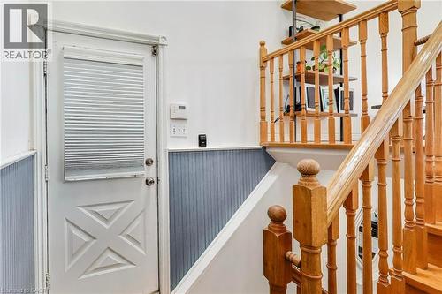 Wood stair railing, beadboard wainscoting, and a door with decorative paneling - 35 Shirlea Boulevard, Keswick, ON 
