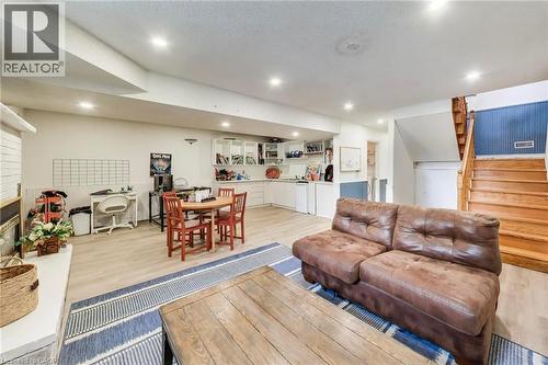Recessed lighting, wood-finish flooring, built-in shelving, white cabinetry, natural wood staircase - 35 Shirlea Boulevard, Keswick, ON 