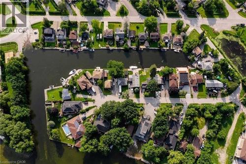 Waterfront properties with private docks, lush green landscaping, and diverse architectural styles - 35 Shirlea Boulevard, Keswick, ON 