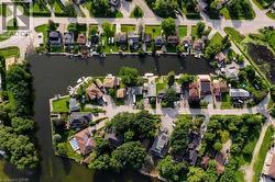 Waterfront properties with private docks, lush green landscaping, and diverse architectural styles - 