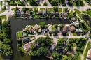 Waterfront properties with private docks, lush green landscaping, and diverse architectural styles - 35 Shirlea Boulevard, Keswick, ON 