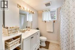 White vanity with an integrated sink, brushed nickel faucet, and a large wall-mounted mirror - 