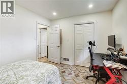 Recessed lighting illuminates neutral-toned walls and wood-finish flooring - 