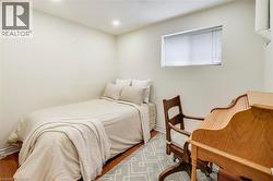 Recessed lighting, wood-finish flooring, and a single window with blinds - 
