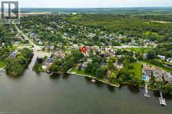 Waterfront property with private dock access and surrounding mature trees - 