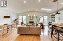 Hardwood flooring throughout, vaulted ceiling, recessed lighting, white brick fireplace, and built-in white cabinetry - 35 Shirlea Boulevard, Keswick, ON 