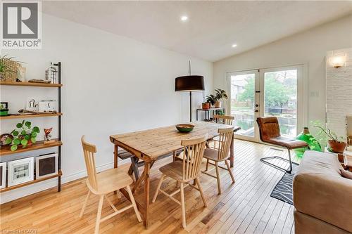 Hardwood flooring, recessed lighting, double French doors, a built-in shelving unit, and a textured accent wall - 35 Shirlea Boulevard, Keswick, ON 
