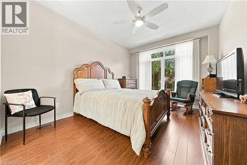 Recessed ceiling fan with integrated lighting, wood-finish flooring, and a large window with vertical blinds - 31 Book Road Unit# 44, Grimsby, ON 
