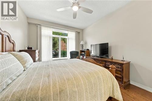 Sliding glass door, ceiling fan, wood-finish flooring, and light-toned walls - 31 Book Road Unit# 44, Grimsby, ON 
