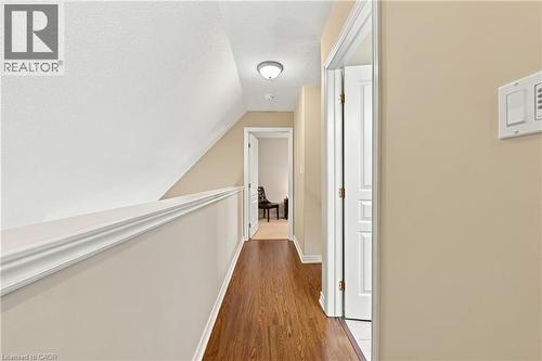 Wood-finish flooring throughout, white interior doors, and a ceiling-mounted light fixture - 31 Book Road Unit# 44, Grimsby, ON 