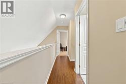 Wood-finish flooring throughout, white interior doors, and a ceiling-mounted light fixture - 
