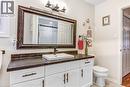 White vanity with dark hardware, vessel sink with dark-finish faucet, and a dark-finish countertop - 150 Oak Street Unit# 27, Simcoe, ON 