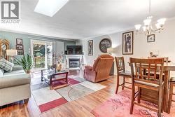Wood-finish flooring throughout, with a recessed ceiling light and a skylight - 