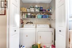 Laundry closet featuring bi-fold doors, wire shelving, and overhead lighting - 