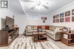 Recessed lighting with a ceiling fan, wall-mounted window, wood-finish flooring, and light-toned walls - 