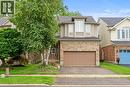 Two-story residence featuring a brick and siding exterior, an integrated garage, and a dormer window - 495 Brigantine Drive, Waterloo, ON 