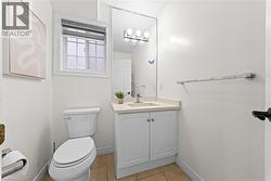 Window with privacy blind, white vanity with integrated sink, polished chrome faucet, full-width mirror, and three-light fixture - 