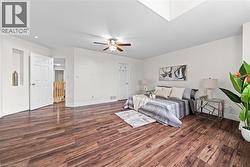 Wood-finish flooring, white walls, ceiling fan, recessed lighting, and a built-in wall niche - 