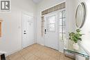 Entryway featuring a main door with decorative glass, two side panels with textured glass, a transom window, and square tile flooring - 495 Brigantine Drive, Waterloo, ON 