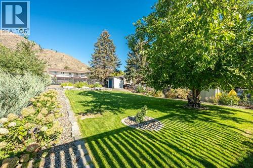 Fenced, landscaped, garden beds, garden shed - 886 Fairview Road, Oliver, BC 