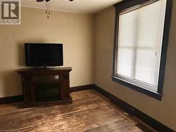 dark wood surround, window with white blinds, and a ceiling fan - 