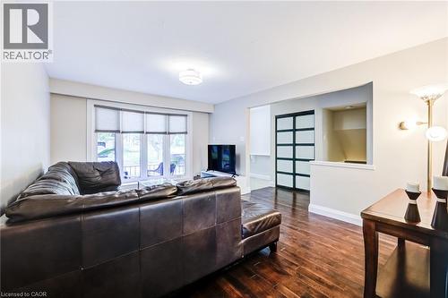 Hardwood-finish flooring, recessed wall niche, contemporary sliding doors, large window with blinds, and ceiling-mounted light fixture - 2037 Mountain Grove Avenue, Burlington, ON 