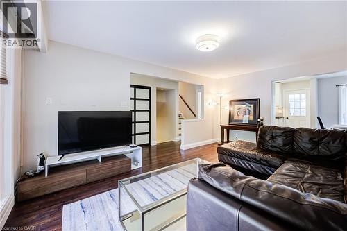 Dark wood-finish flooring throughout, light-toned walls, and a ceiling-mounted light fixture - 2037 Mountain Grove Avenue, Burlington, ON 