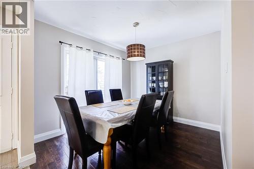 Dark wood-finish flooring, white wall paint, crown molding, and a drum pendant light fixture - 2037 Mountain Grove Avenue, Burlington, ON 