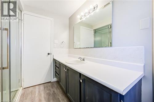 Vanity with integrated sink, chrome faucet, and dark wood-finish cabinetry - 2037 Mountain Grove Avenue, Burlington, ON 