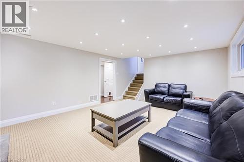 Recessed ceiling lighting, light-toned carpeting, a light gray wall color, white trim, and a window - 2037 Mountain Grove Avenue, Burlington, ON 