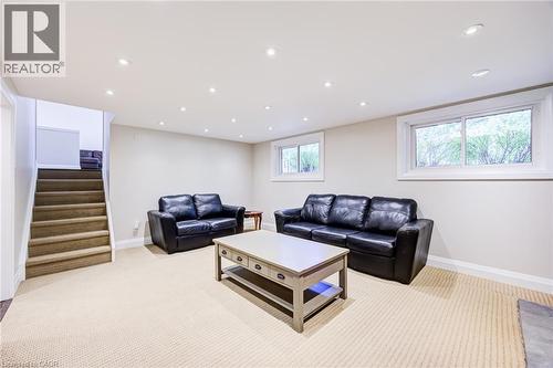 Recessed lighting throughout, two windows with white trim, and a carpeted staircase - 2037 Mountain Grove Avenue, Burlington, ON 