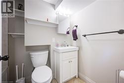 White vanity with a rectangular basin sink, chrome faucet, and storage cabinet - 