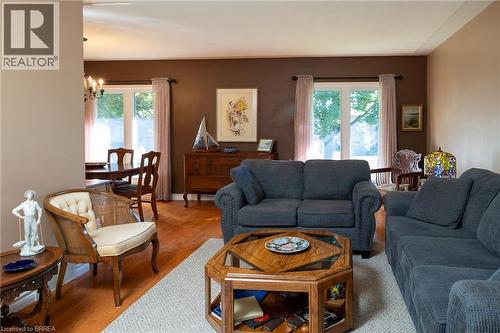 Hardwood-style flooring throughout, with a recessed wall separating spaces - 78 Berkley Crescent, Simcoe, ON 