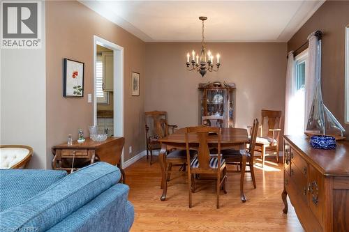 Wood-finish flooring throughout, with a classic chandelier and crown molding - 78 Berkley Crescent, Simcoe, ON 