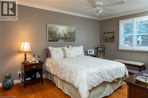 Hardwood flooring, crown molding, white window shutters, and a ceiling fan - 78 Berkley Crescent, Simcoe, ON 