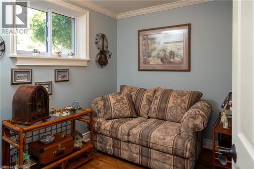 Hardwood flooring, painted walls, crown molding, and a white-framed window - 78 Berkley Crescent, Simcoe, ON 