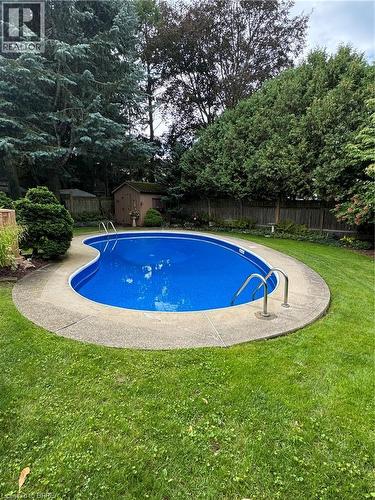 Curved in-ground swimming pool with a concrete surround - 78 Berkley Crescent, Simcoe, ON 